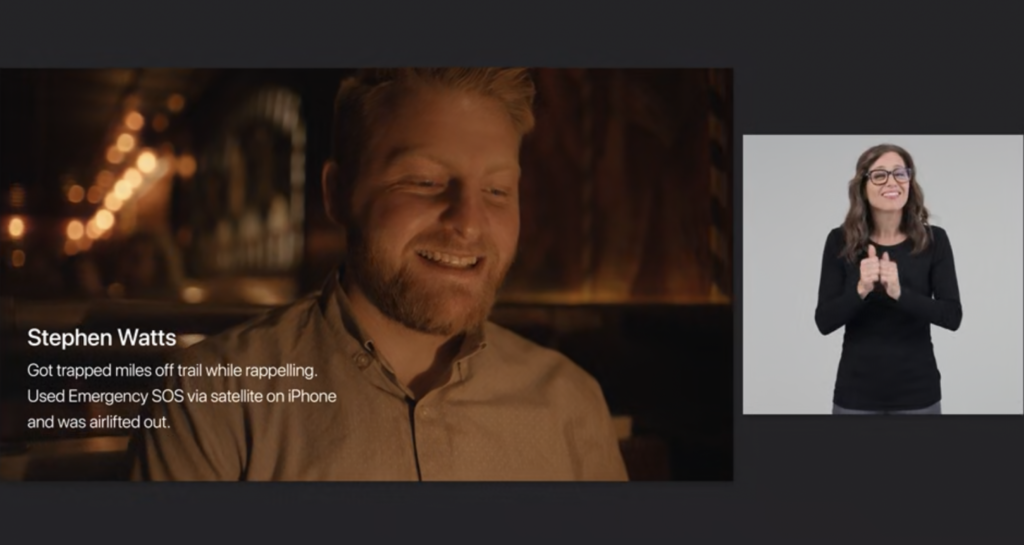 A scene from the Apple Event showing a man named Stephen Watts who got trapped miles off trail while rapelling. He used Emergency SOS via satellite on iPhone and was airlifted out. On the right side of the screen, the message is also being translated live to a sign language.