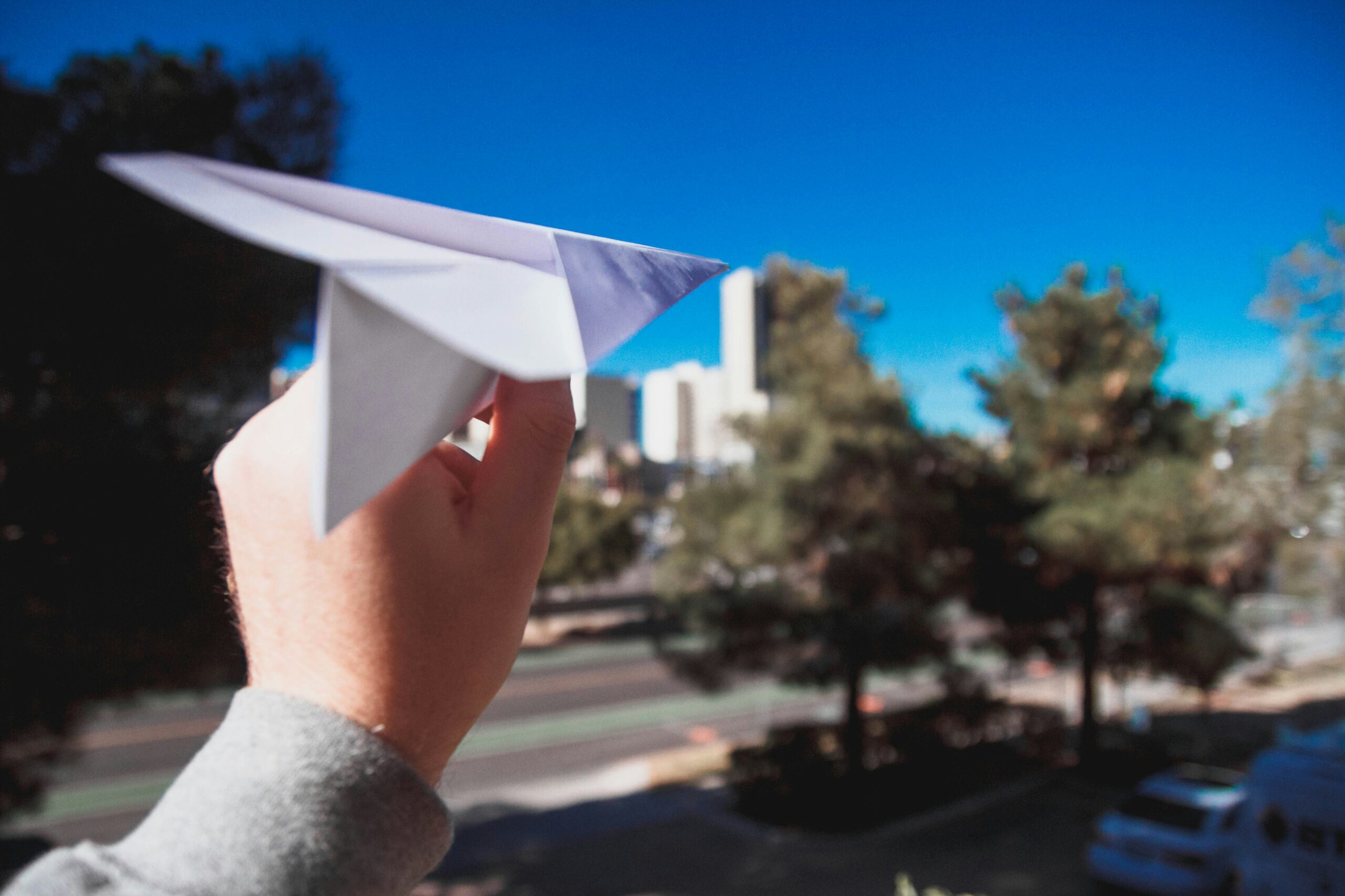 Hand holding a paper plane.